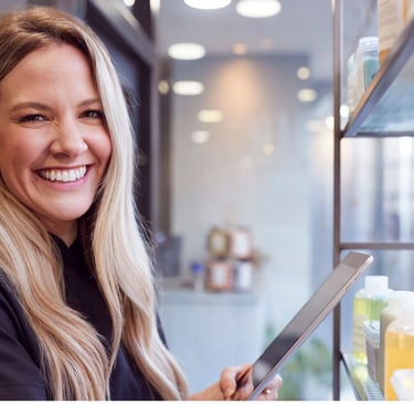 Smiling business owner with tablet in retail store
