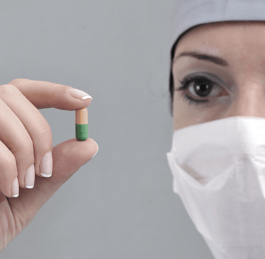 Scientist holding pill