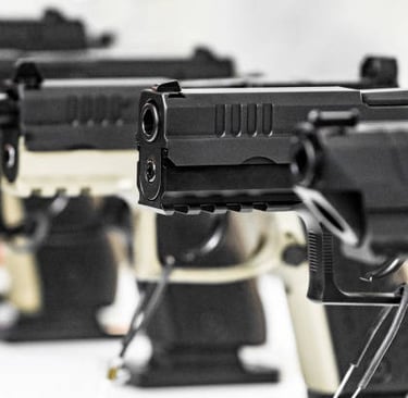pistols in a row and on display at a gun show booth