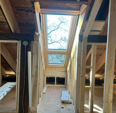 a lofted room with a skylight and a skylight