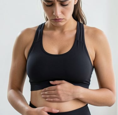 A woman in fitness wear holding her stomach in pain, depicting digestive issues or cramps.