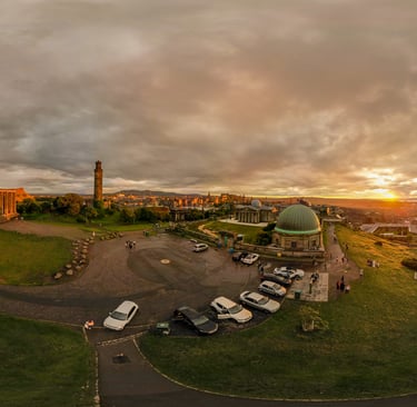 Calton hill at sunset with golden glow across the city of Edinburgh