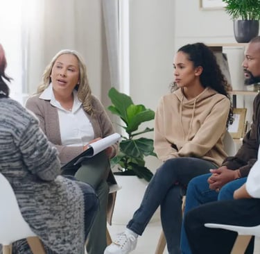 Multiple staff sitting in a mental wellness meeting