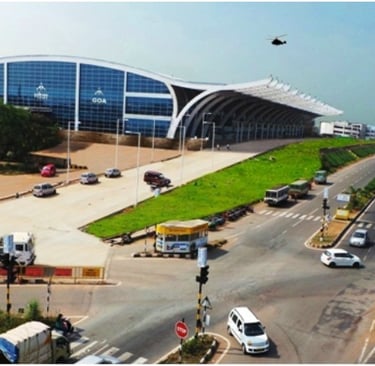 a goa airport terminal with a lot of cars moving in front of it