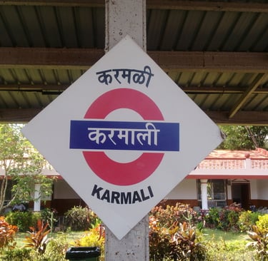 a sign that says Karmali in Marathi, english and hindi
