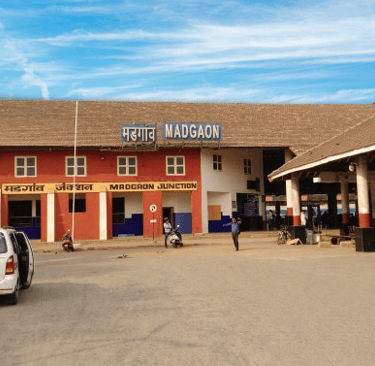 a car parked in front of a Margao railway station building