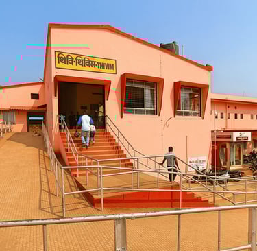 a man walking up at the stairs of a thivim railway station building