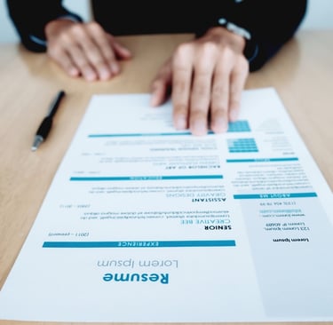 a person sitting at a table with a resume from ededge