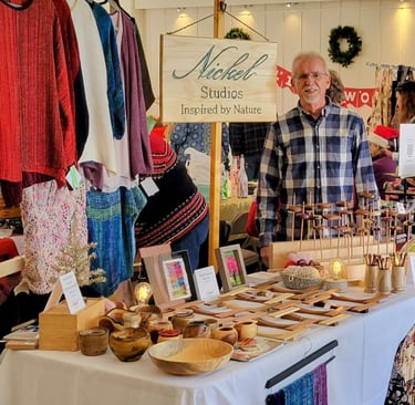 Photo of Nickel Studios vendor table at a fiber conference. Depicts items listed on this website. 