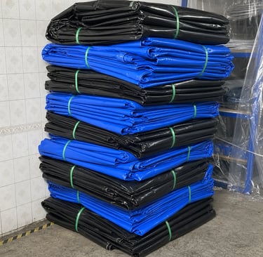 PVC Tarpaulin Sheets are stacked in the warehouse