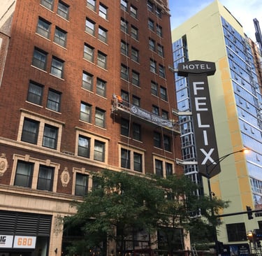 Facade restoration of the high-rise Hotel Felix building using suspended scaffolding.