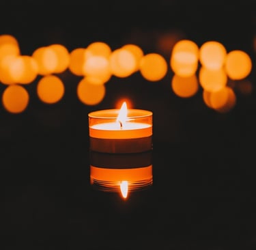 A candle with lights around it