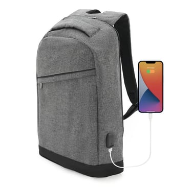 Grey anti-theft laptop backpack with a built-in USB charging port connected to a smartphone.