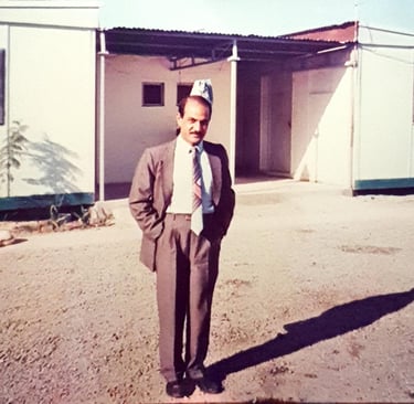 Ravinder Vashisht in front of building in Iraq