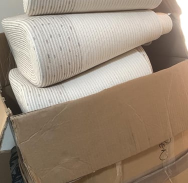 a stack of boxes with a lot of bags 