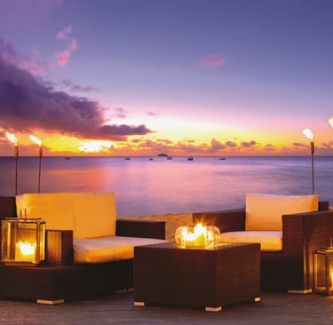Romantic Barbados beach at sunset with golden sky and ocean waves, capturing the beauty of a Caribbe
