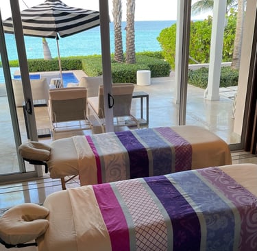 two massages by sophia massage beds in a room with a view of the ocean
