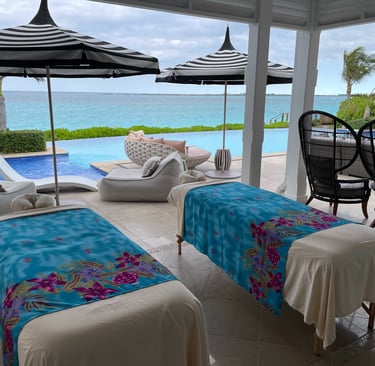 a couple of massages by sophia beds outdoor by a pool and ocean view