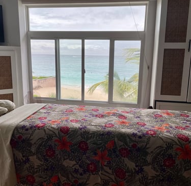 a massages by sophia massage table with a colorful sheet in a room with an ocean view