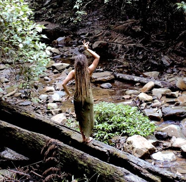 a woman with dreadlocks in the rainforest