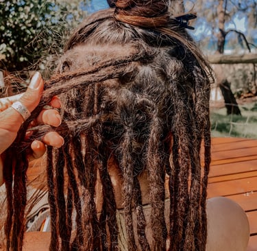 a woman with dreadlocks in her hair