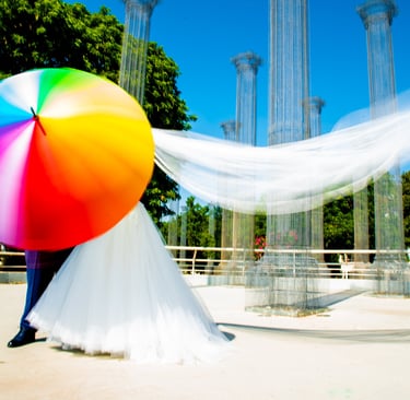 sposi che si divertono con un coloratissimo ombrello