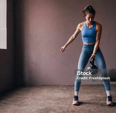 a woman holding a kettlebell