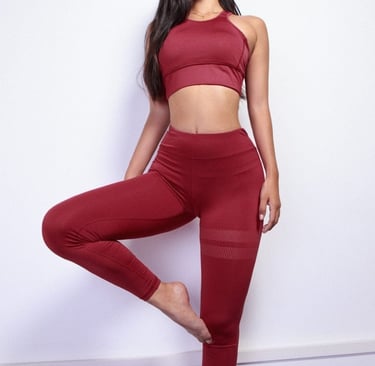 a woman in a red sports bra top and leggings