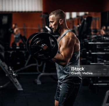 a man doing a barbell exercise in a gym