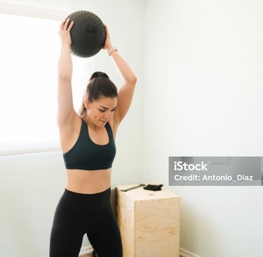 a young lady holding an exercise ball