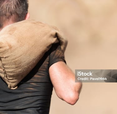 a man carrying a sandbag