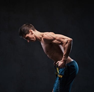 a man with a muscular body using resistance bands
