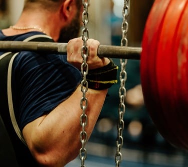 a man is doing a barbell exercise