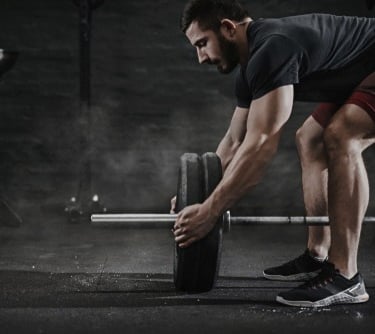 a man is doing a barbell exercise