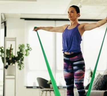 a young lady using resistance bands
