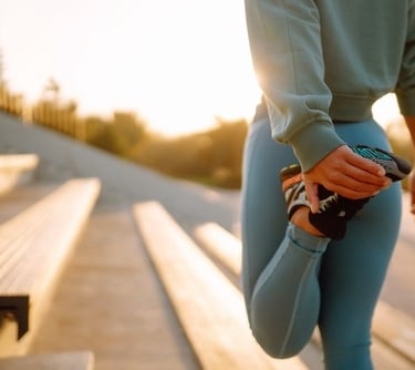 a woman in blue leggings stretching