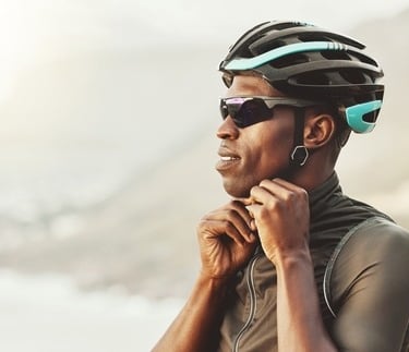 a man in a helmet and sunglasses on a mountain