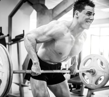 a muscular man using a barbell