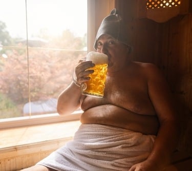 a man in a bathrobe with a glass of beer in a sauna