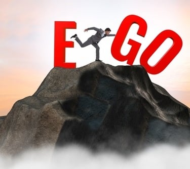 a man standing on top of a mountain with a large letter e on it