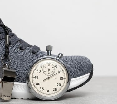 a stopwatch watch and a sneaker