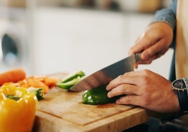 a person is cutting up peppers on a cutting board