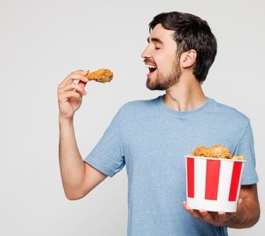 a man eating a fried chicken nuggies