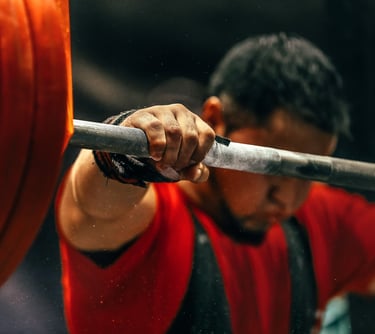 a man is holding a barbell in his hand