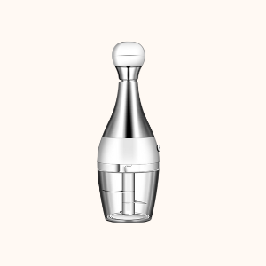 Sleek hand chopper resembling a bottle, with a stainless steel and white finish