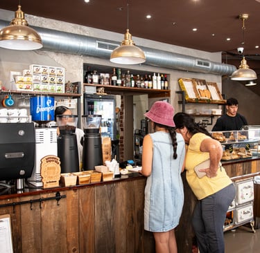 Customers being served at Cafe Breslau, a partner of Bencomo Coliving.