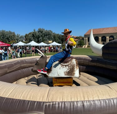 Alex Accetta on a bucking bull when dressed as Woodie from Toy Story