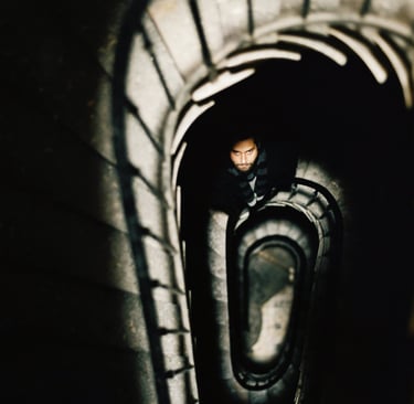 Dorian Chamoin is standing in a spiral staircase way