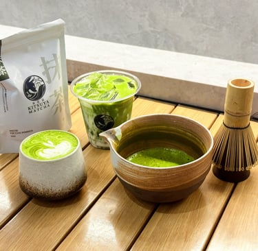 Iced and hot Cafe Kitsune matcha green tea lattes with bamboo whisk and ceramic bowl.