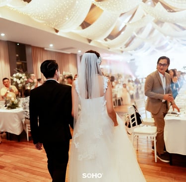 a bride and groom are standing in front of a wedding party